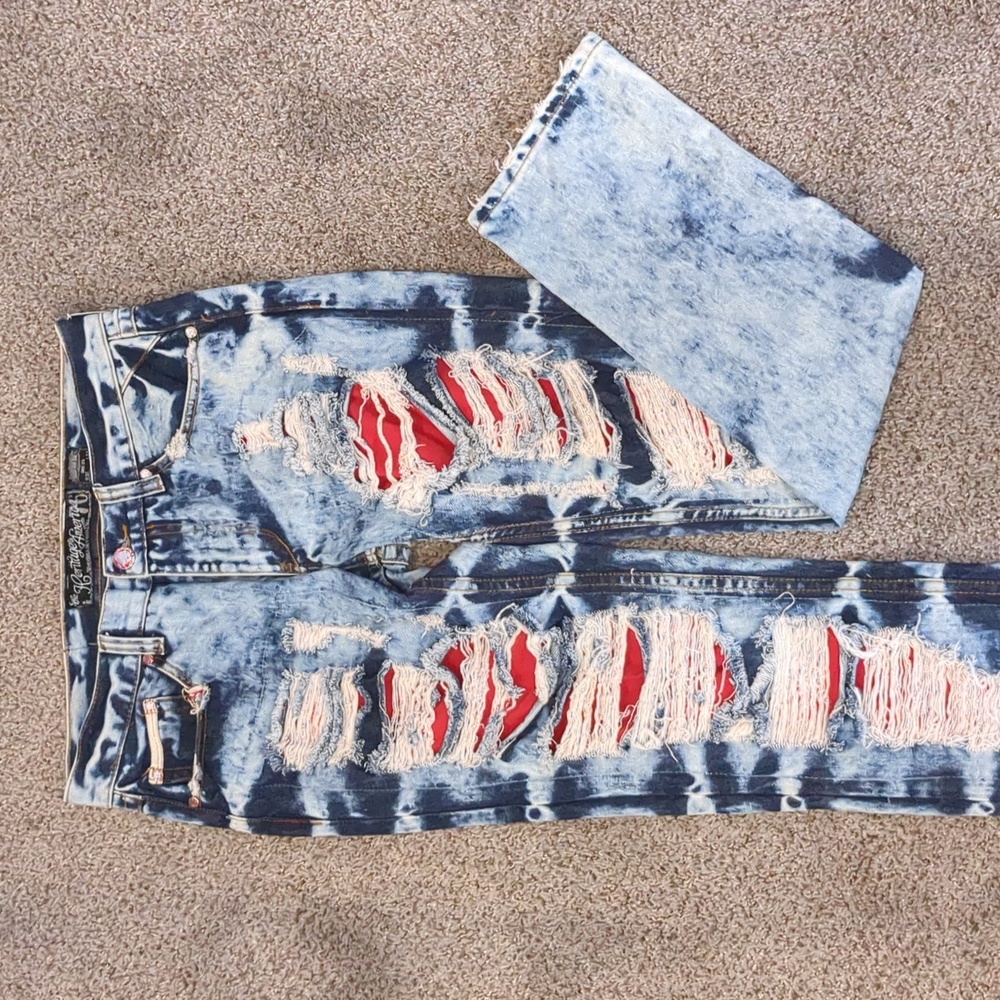 The Heritage by Americana men's size 32W x 33L distressed jeans with red accent.